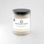 Coconut Cardamom + Cream 9 oz soy candle shown lit in a warm home setting - Noir Glow Candles