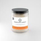 Peppered Passionfruit 9 oz soy candle shown lit in a warm home setting - Noir Glow Candles